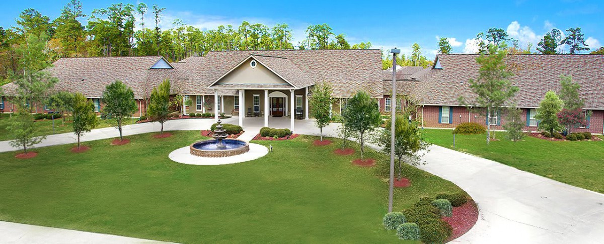 A beautiful house with a well-maintained garden and fountain.