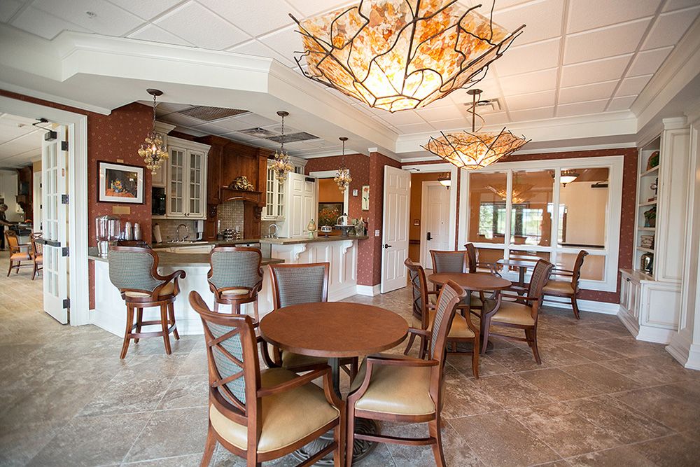 A cozy dining space with elegant wooden furniture and decorative chandeliers.