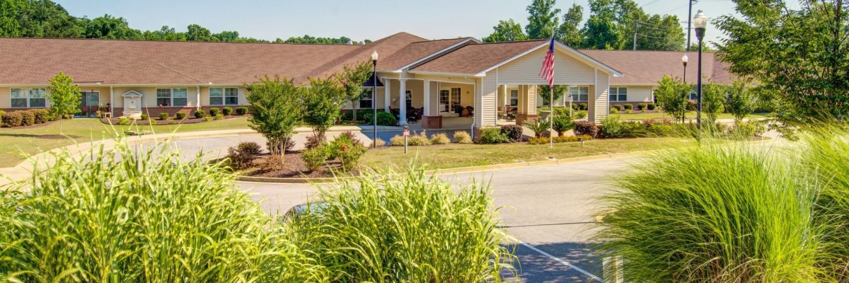 A well-maintained suburban house with a front porch and landscaped yard.