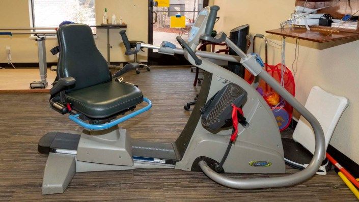 A recumbent exercise bike in a gym setting.