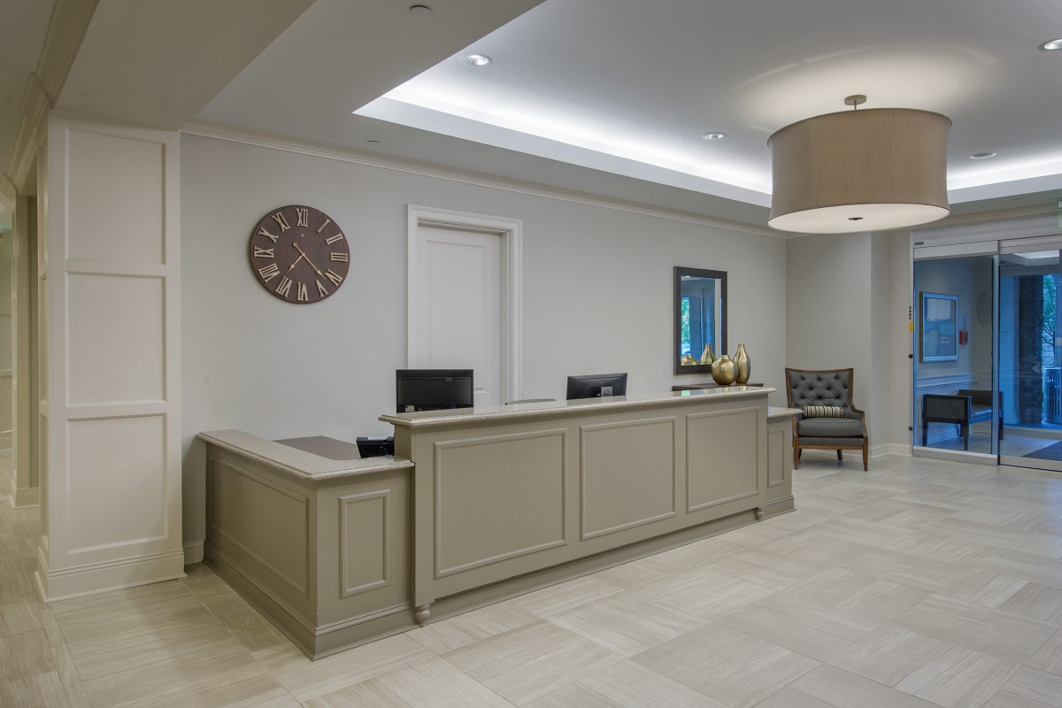 A modern reception area featuring a large desk and comfortable seating.