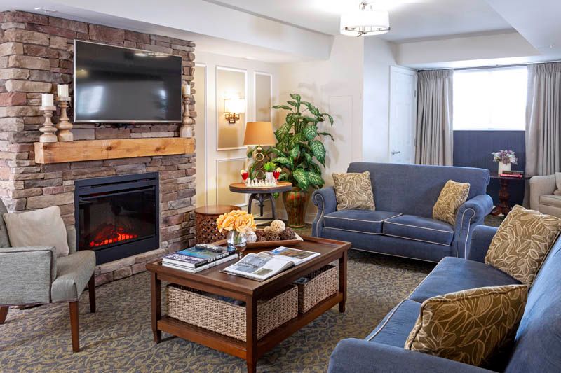 A cozy living room featuring a fireplace, comfortable sofas, and a stylish coffee table.