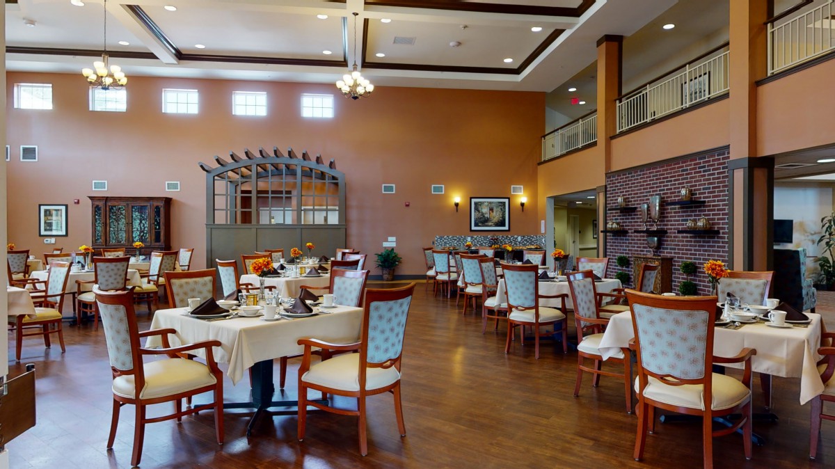 An elegant and spacious dining room with neatly arranged tables and chairs.