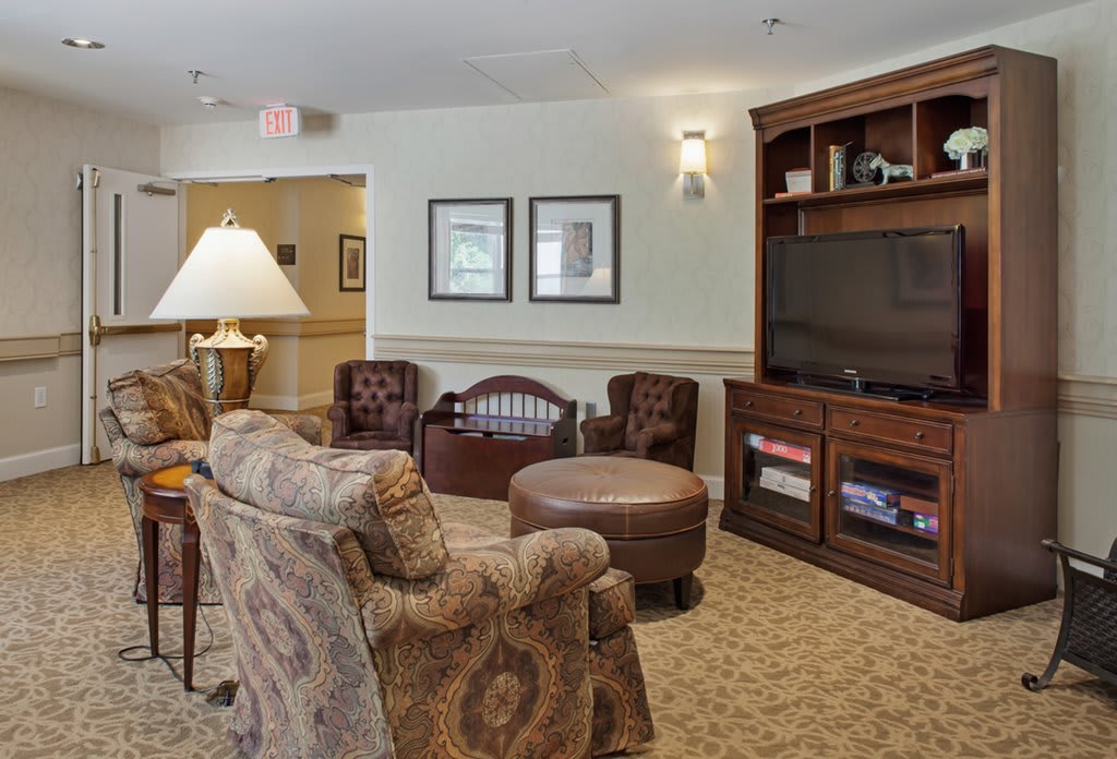A cozy living room with comfortable seating and a large television.