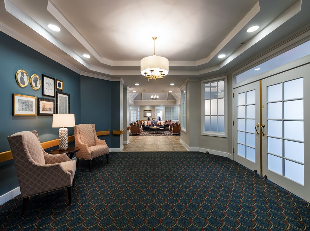 A well-decorated lobby area featuring comfortable seating, elegant lighting, and a mix of traditional and modern elements.