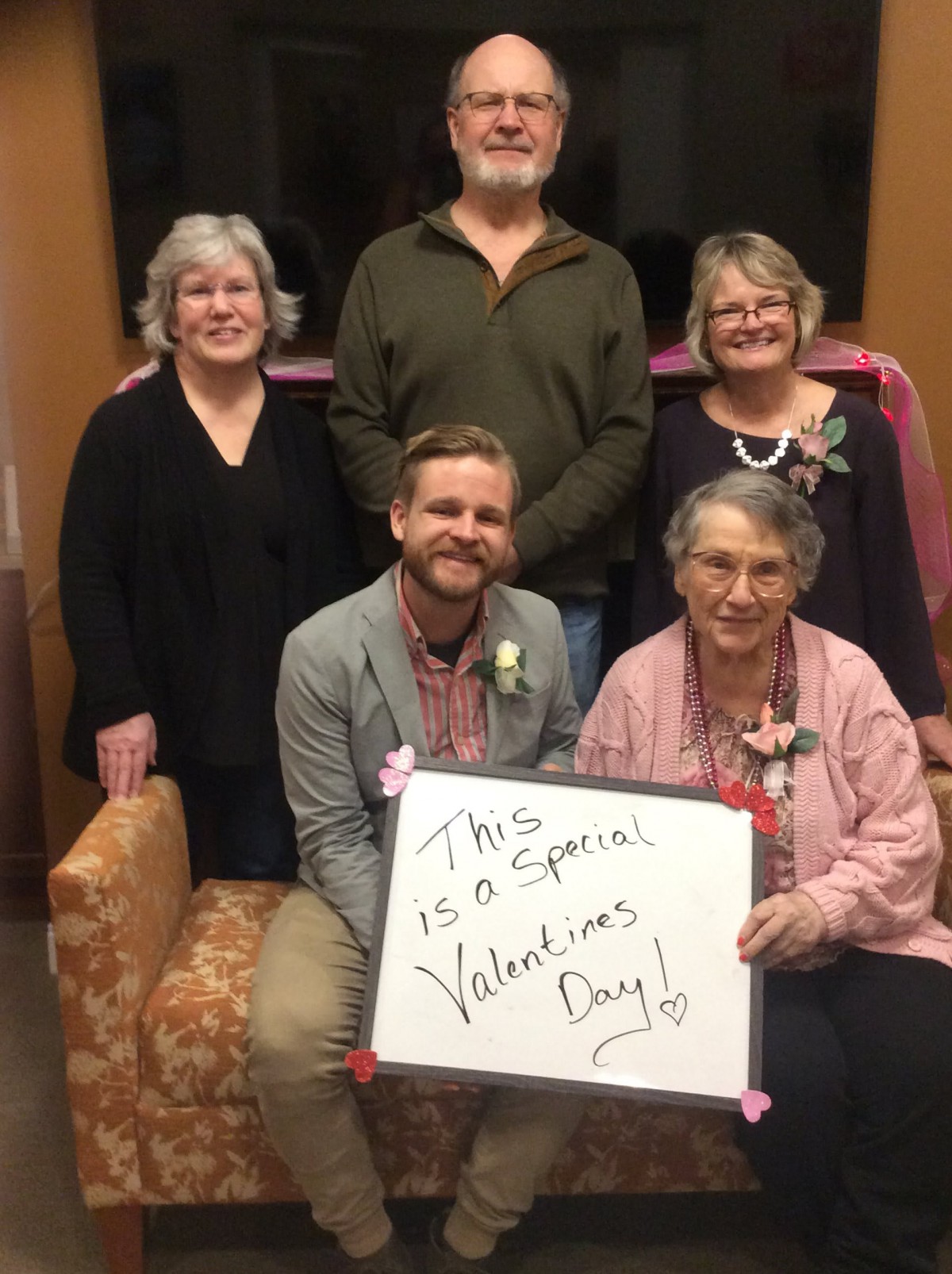 A group of people posing with a sign that reads 'This is a special Valentine's Day!'