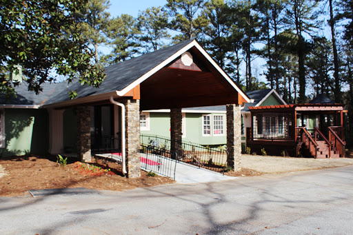 A charming residential house featuring a stone faade and inviting porch.