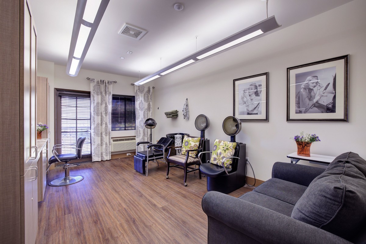 A cozy salon with seating and hair drying stations.