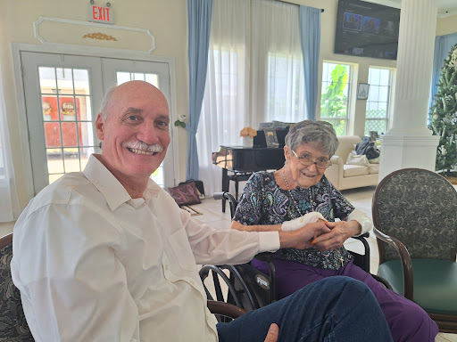 A joyful moment shared between two friends in a cozy indoor setting.