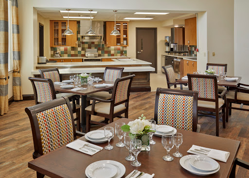 A beautifully arranged dining area with a modern kitchen in the background.