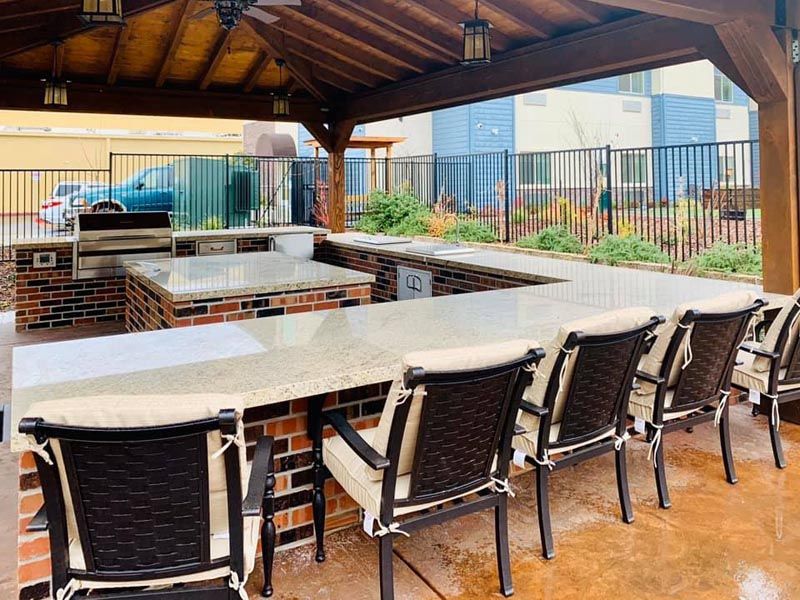 An outdoor patio bar area with a covered roof and seating.