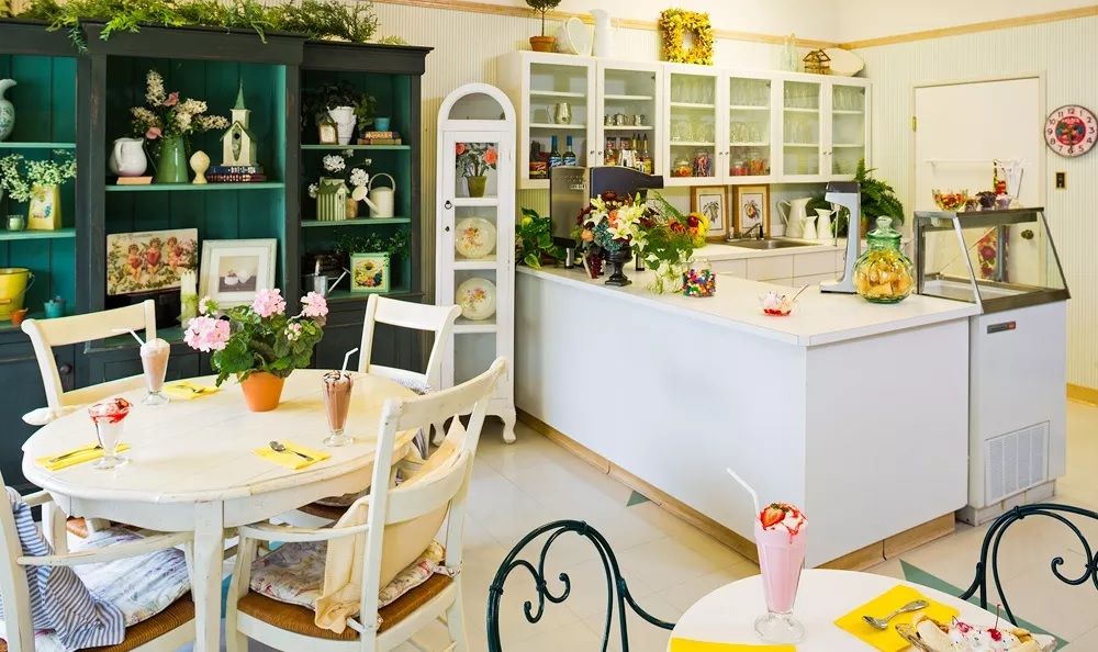 A charming vintage-style cafe interior with bright decor and cozy furnishings.