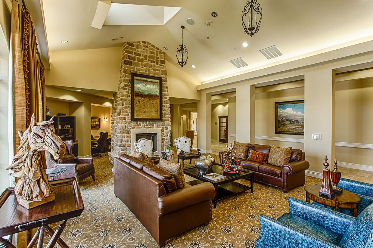 A cozy living room with comfortable sofas, a fireplace, and decorative artwork.