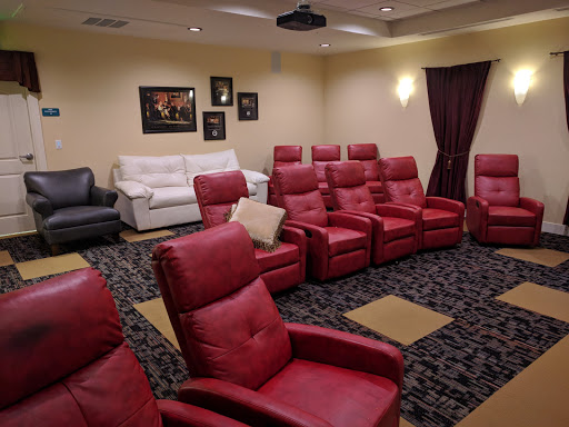 A comfortable home theater featuring red reclining chairs, perfect for movie nights.