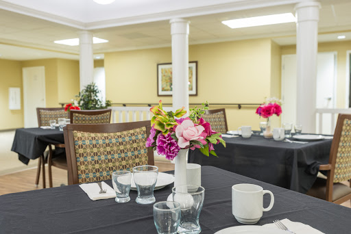 A beautifully arranged dining area with floral centerpieces and elegant table settings.