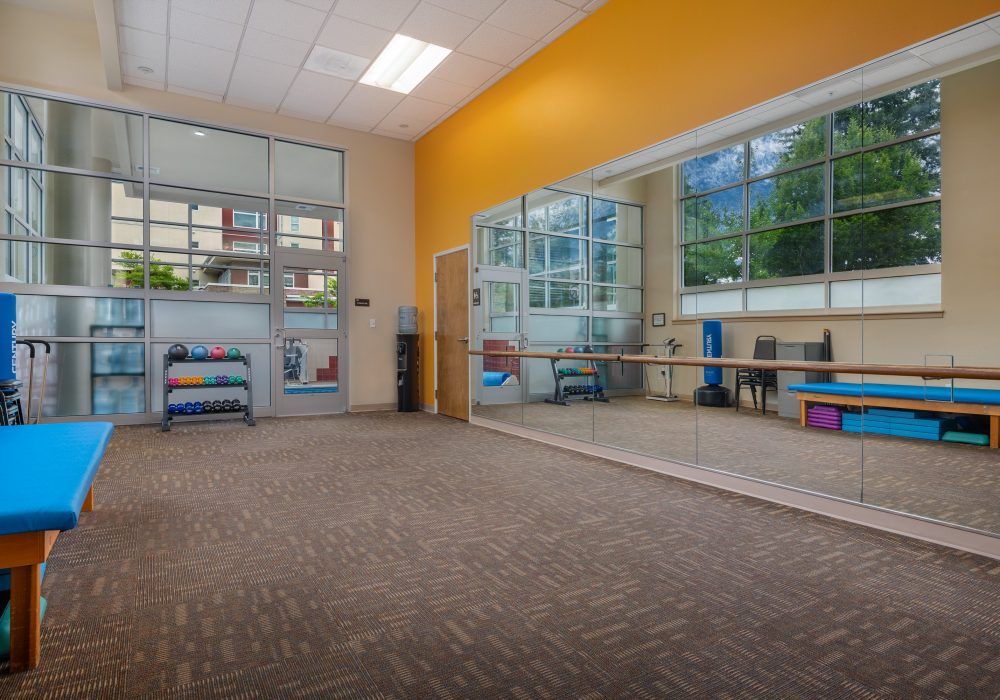 Spacious dance studio with large mirrors and natural lighting.