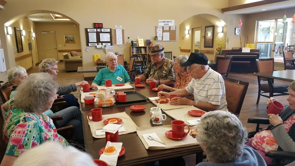 A group of seniors enjoying a meal together at a community center.