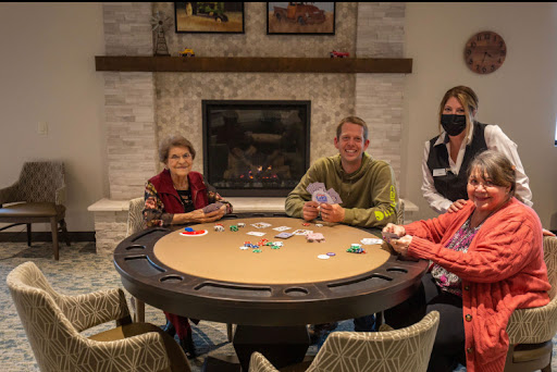 A group of friends enjoying a game of poker around a gaming table in a cozy indoor setting.