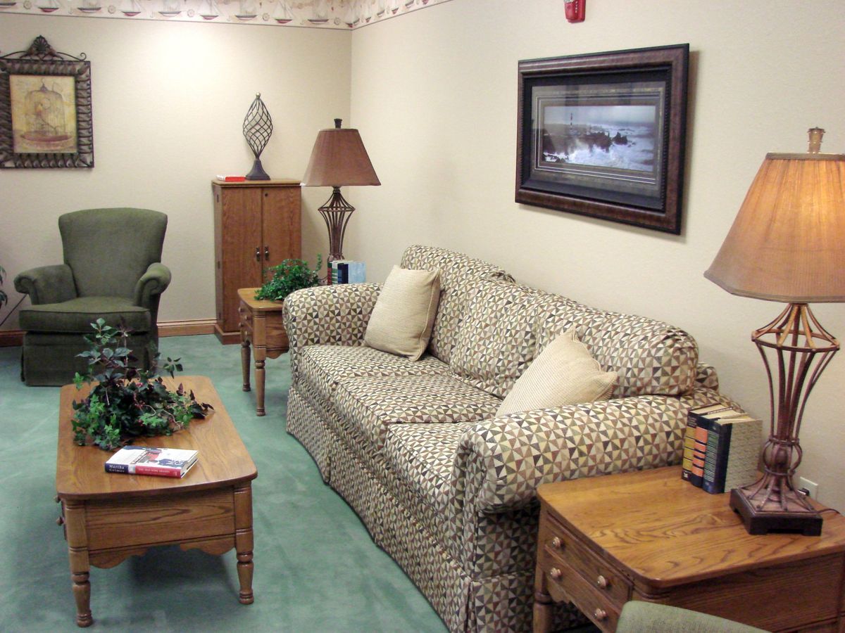 A cozy living room with patterned sofa, coffee table, and classic decor.