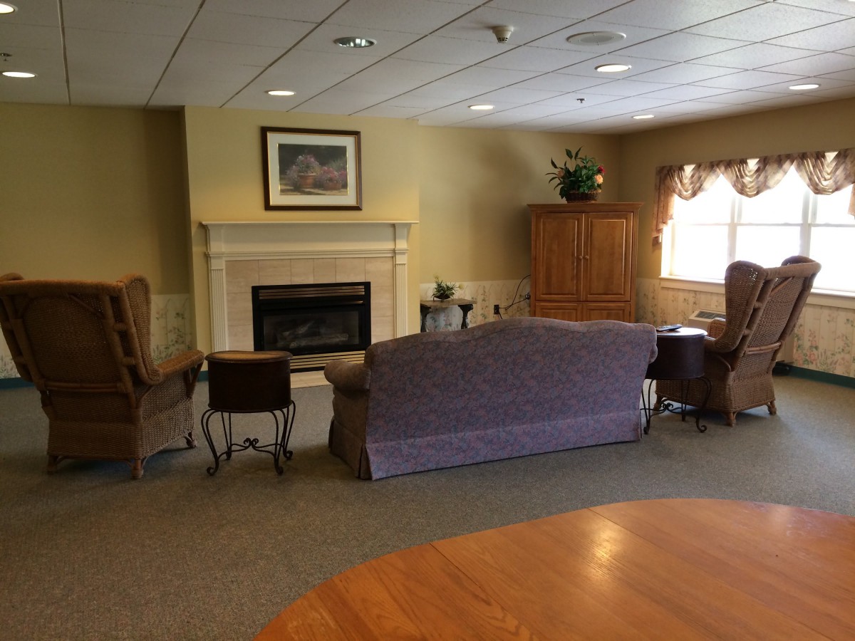 A cozy living room with a fireplace and comfortable seating.