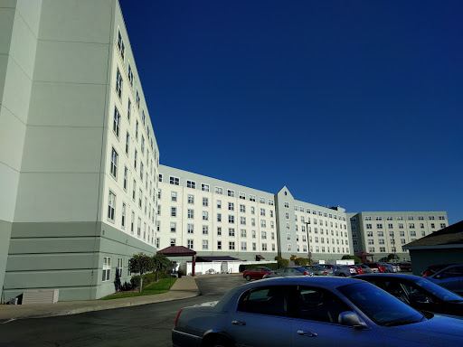 A view of a multi-story hotel building under a clear blue sky.