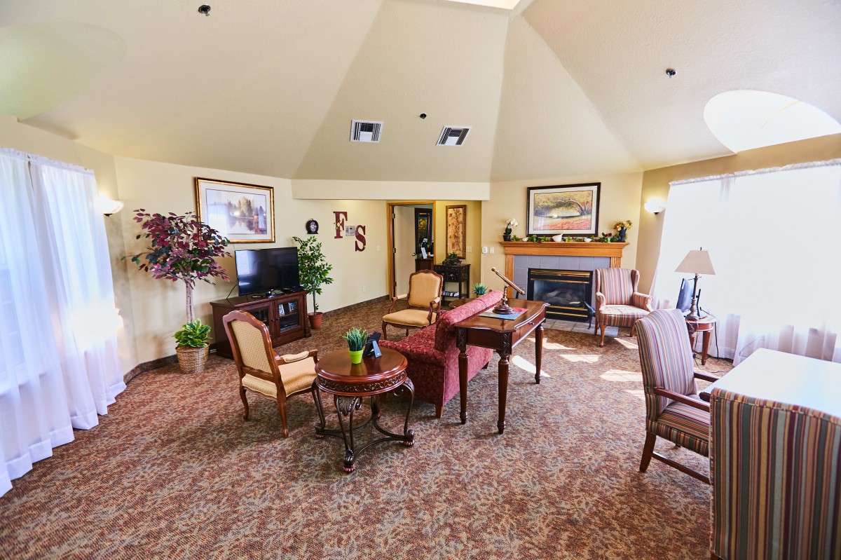 A cozy living room with comfortable seating, a fireplace, and decorative elements.