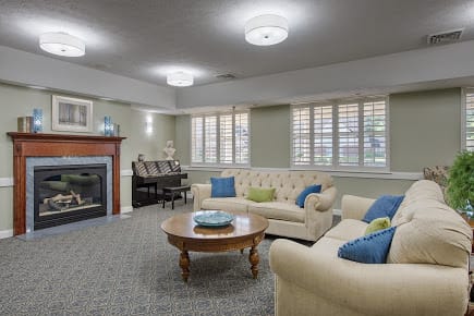 A cozy living room with comfortable sofas, a fireplace, and elegant decor.