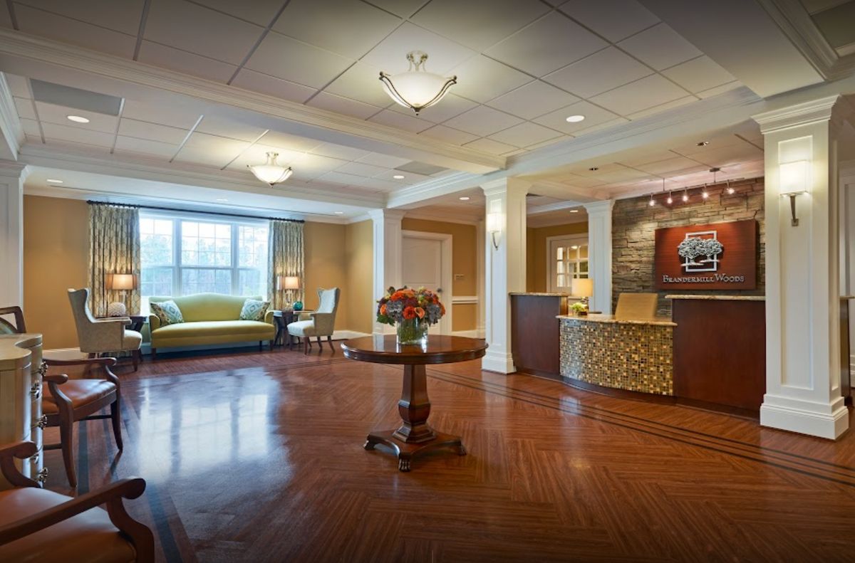 A spacious and elegant lobby with a reception desk and seating area.