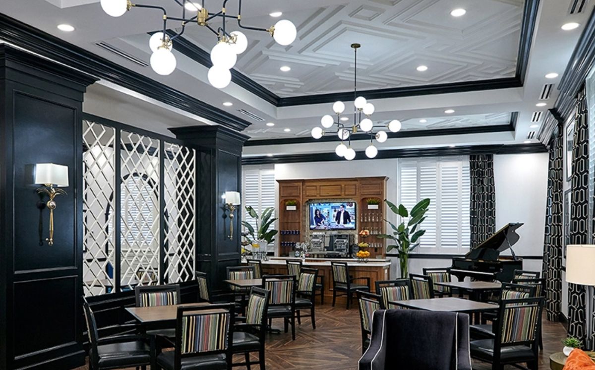 A modern and elegant restaurant dining area with chandeliers and stylish furniture.