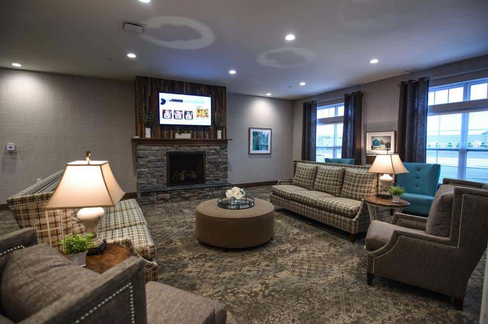 A cozy and modern living room with comfortable sofas, a fireplace, and stylish decor.