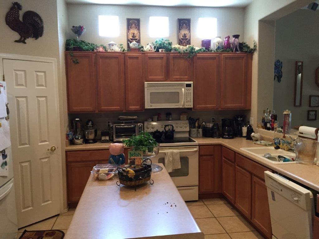 A cozy kitchen with wooden cabinets, a countertop, and various appliances.