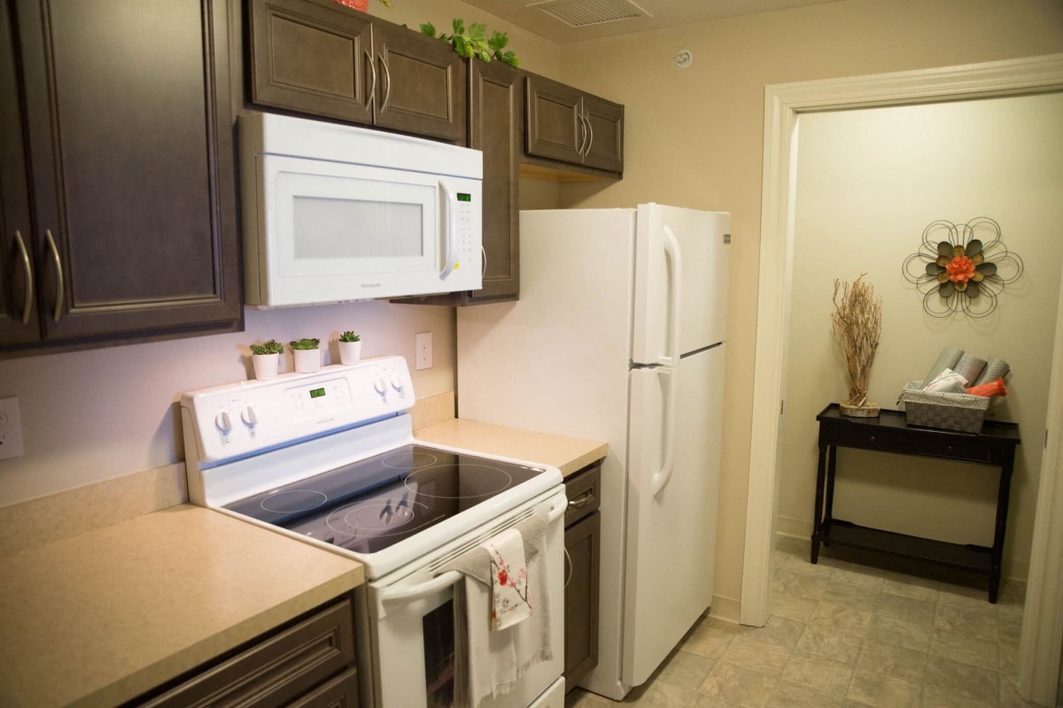 A modern kitchen with essential appliances including a stove, microwave, and refrigerator.