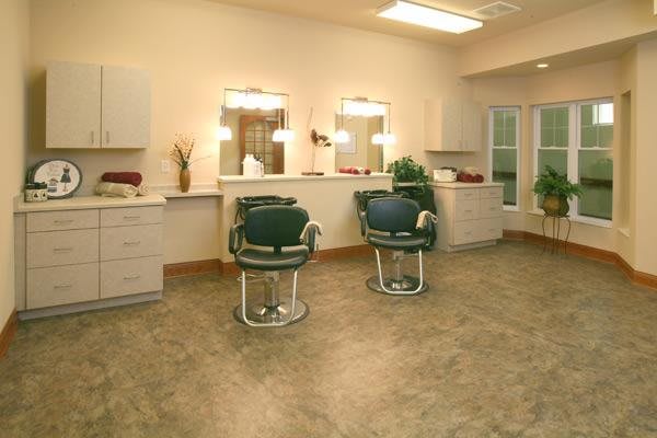 An interior view of a hair salon with two chairs and mirrors.
