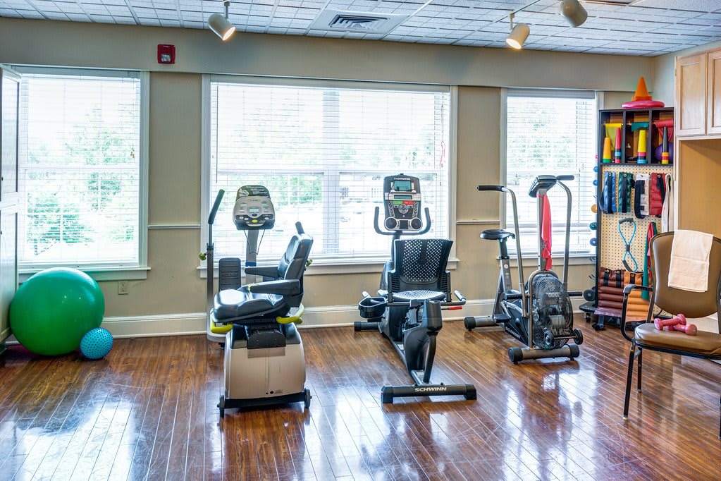 A well-lit gym featuring various exercise machines for fitness enthusiasts.