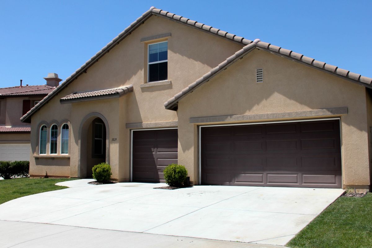A modern suburban house with a double garage and a clean driveway.