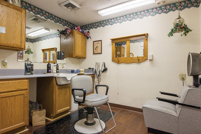 Cozy barber shop interior with a vintage chair and mirror setup.