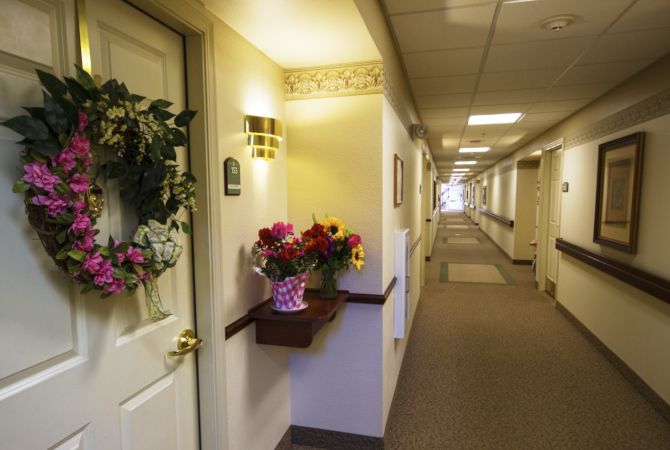 A warmly decorated hallway with flowers and lighting.