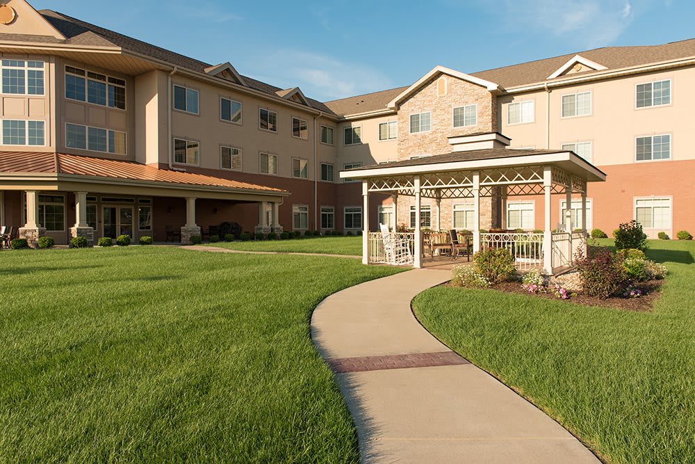 A well-maintained residential building with a garden and a winding pathway.