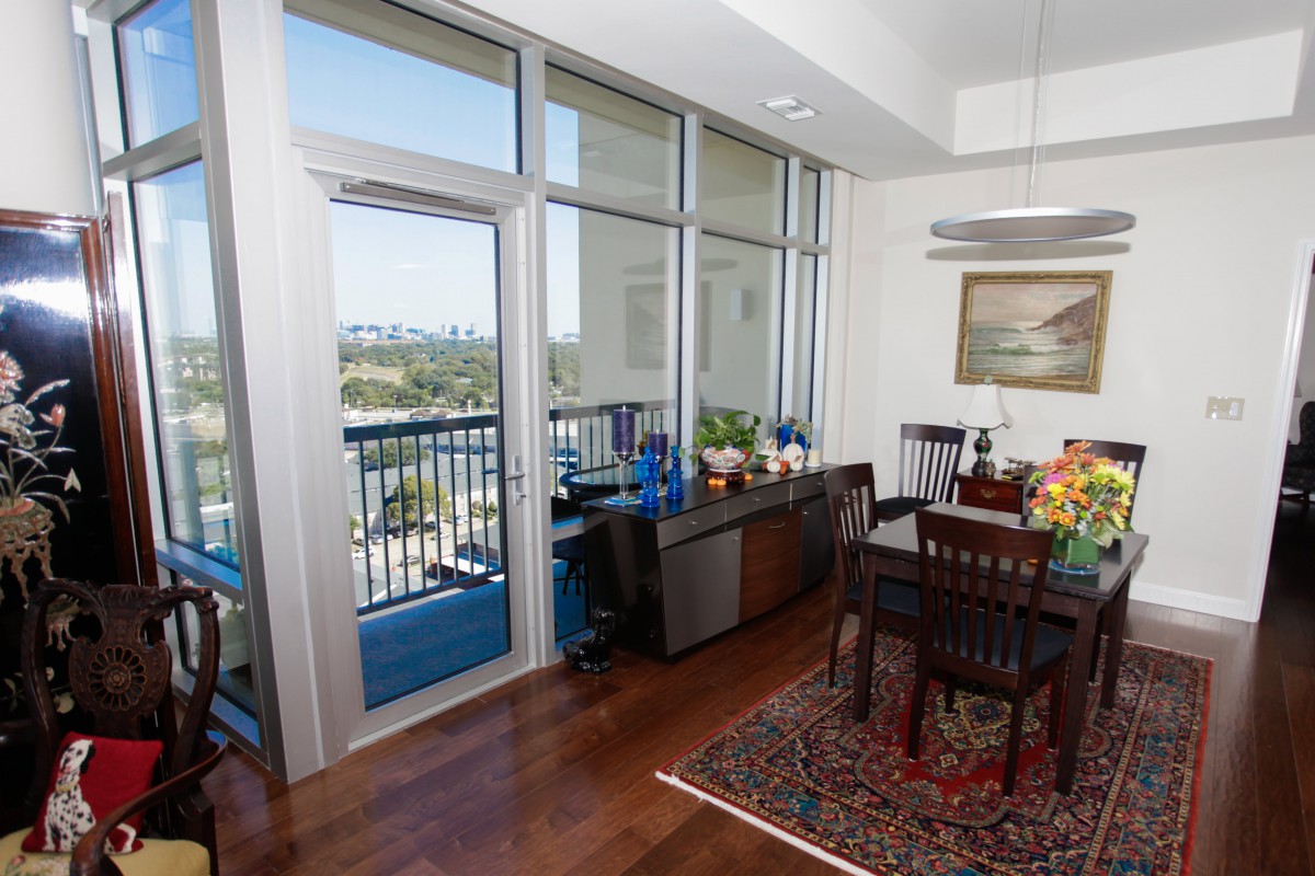 A modern dining area with large windows and a city view.