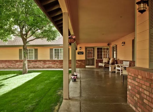 A welcoming porch leading to a cozy entrance surrounded by greenery.