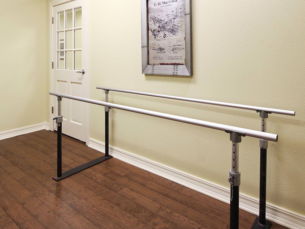 Parallel bars for physical therapy and rehabilitation in an indoor setting.