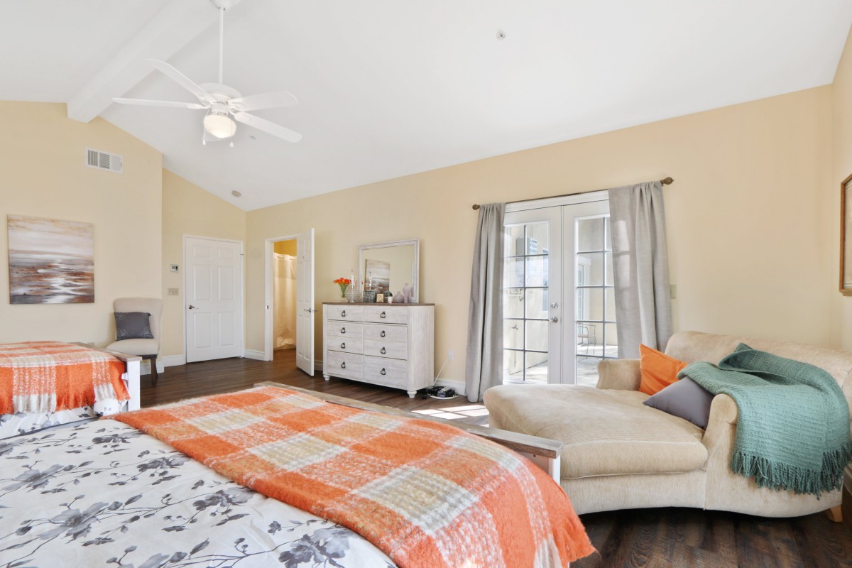 A bright and spacious bedroom with modern decor and comfortable furnishings.