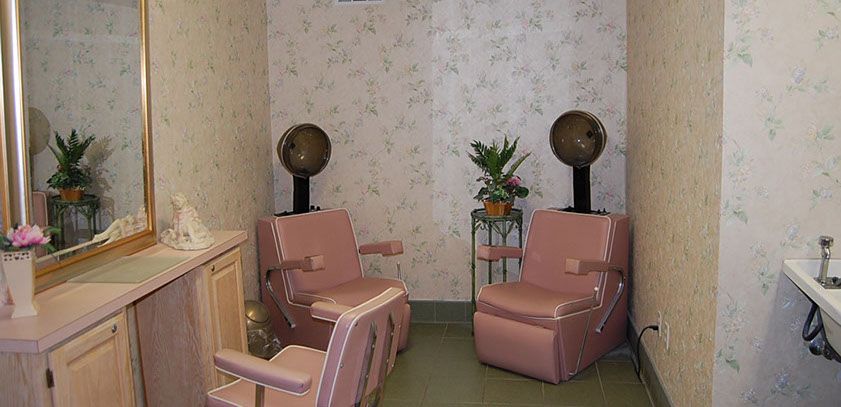 A vintage-style salon with retro chairs and classic hair dryers.