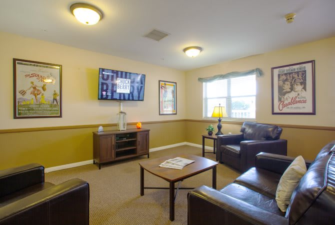 A cozy living room with a television, sofas, and a coffee table.