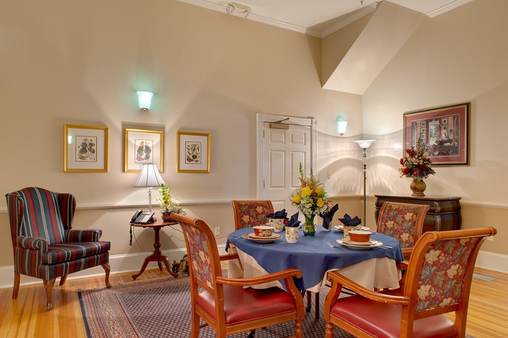 A cozy dining room with a neatly set table and elegant decor.