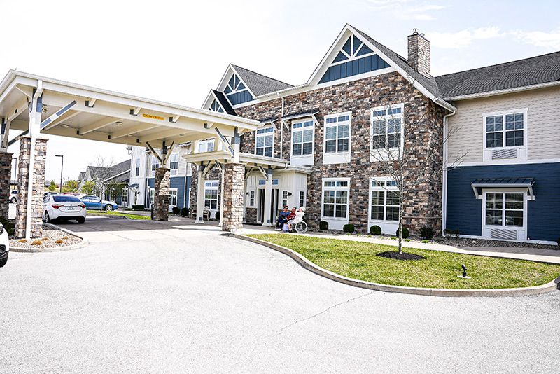 A residential building with a stone exterior and a covered entrance.