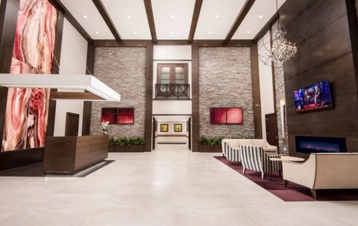 A modern hotel lobby with a reception desk and stylish seating area.