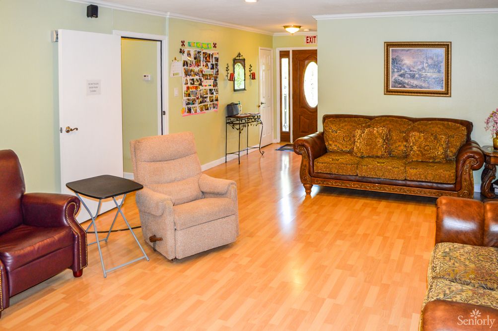 A cozy living room with a sofa and armchair on a wooden floor.