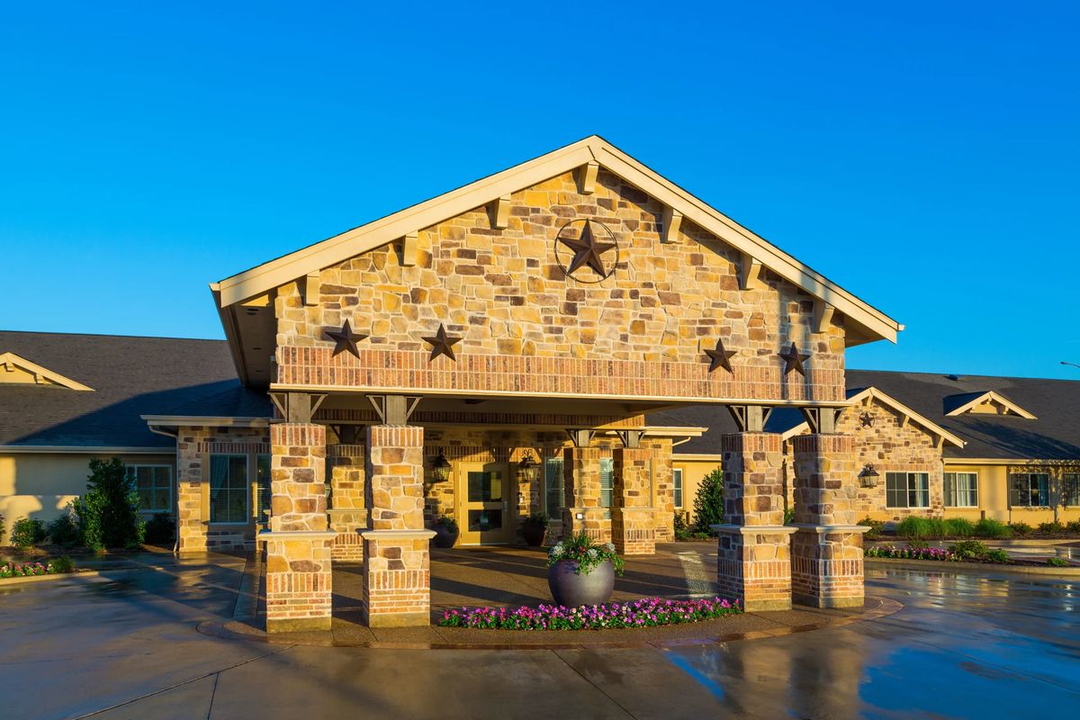 A stone building entrance adorned with star decorations on a clear day.