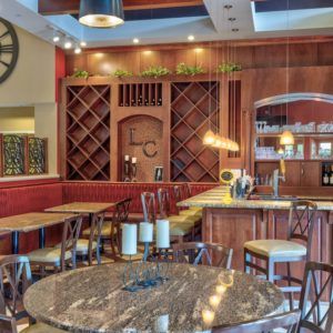 Cozy restaurant interior with a well-organized wine rack and inviting seating area.
